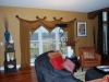 triangle-valances-mounted-on-medallions-with-bead-tassels-over-panels-puddled-on-floor