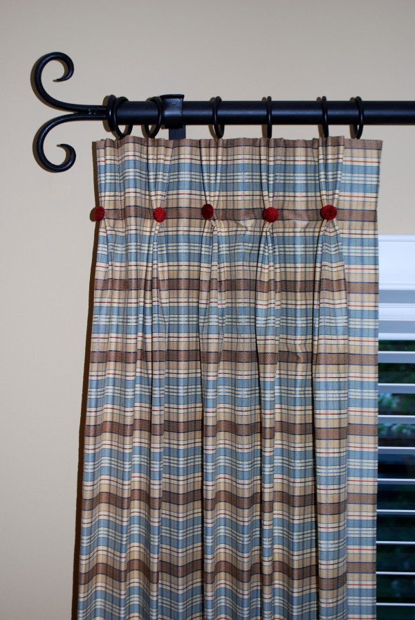 Close up of pinch pleat drapes with contrast covered buttons.